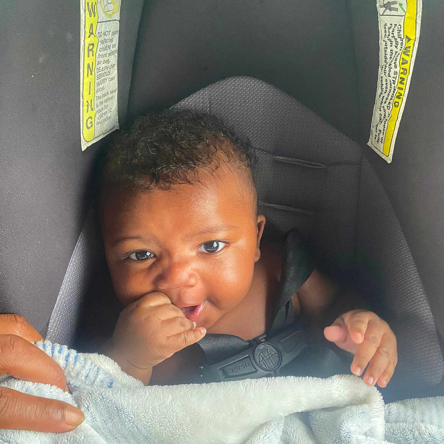 Jamius joined the competition — help win amazing prizes! baby, blanket, car_seat, child, closeup, comfort, curly_hair, cute, expression, face, hand, happy, indoors, infant, person, safety, seatbelt, skin, smiling, toddler