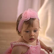 Eva joined the competition — help win amazing prizes! child, toddler, pink_dress, headband, roses, pearl_details, portrait, indoors, soft_light, curly_hair, baby, cute, young_child, face, expression, person, fashion, elegant, background_blur, skin