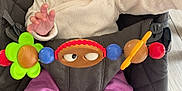 Sophia a rejoint le concours — aidez-le/la à gagner de superbes lots ! baby, smiling, headband, purple_pants, heart_patch, white_socks, wooden_toys, green_flower_toy, cushioned_seat, baby_seat, happy, child, indoors, cute, infant, playtime, person, closeup, portrait, clothing