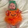 Harlow joined the competition — help win amazing prizes! baby, infant, orange, green, headband, pumpkin, costume, tulle, blanket, cute, smile, lying_down, child, face, legs, clothing, toddler, festive, holiday, soft