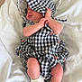 Harlow joined the competition — help win amazing prizes! baby, infant, child, blanket, bed, clothing, outfit, bonnet, socks, white, checkered, pattern, cute, sleeping, resting, human, newborn, soft, fabric, portrait