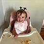 toddler, child, high_chair, bib, food, snack, smile, happy, indoor, pigtails, hair, face, person, baby_food, plastic, tray, feeding, cute, messy, eating