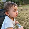toddler, child, baby, portrait, profile, outdoor, garden, backyard, grass, trees, fence, chair, sitting, curious, side_view, short_hair, white_shirt, snack, pouch, daylight