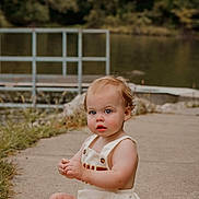 Kylo joined the competition — help win amazing prizes! toddler, child, baby, outdoor, lake, water, concrete_path, grass, trees, greenery, romper, sitting, barefoot, curious, nature, summer, portrait, young_child, daylight, casual_clothing