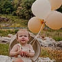 Kylo joined the competition — help win amazing prizes! baby, child, balloons, grass, outdoor, nature, basket, curious, sitting, greenery, plants, infant, portrait, daylight, field, one_person, casual_clothing, rocks, smiling, cute