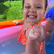 Mazikeen joined the competition — help win amazing prizes! child, toddler, smiling, happy, swimming, pool, kiddie_pool, water, swimsuit, outdoor, summer, grass, trampoline, portrait, close_up, wet, teeth, fist, colorful, playtime
