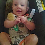 Vincent joined the competition — help win amazing prizes! baby, child, infant, car_seat, brush, comb, clothing, onesie, smiling, happy, face, hands, feet, indoor, person, cute, young, seatbelt, car_accessory, comfort