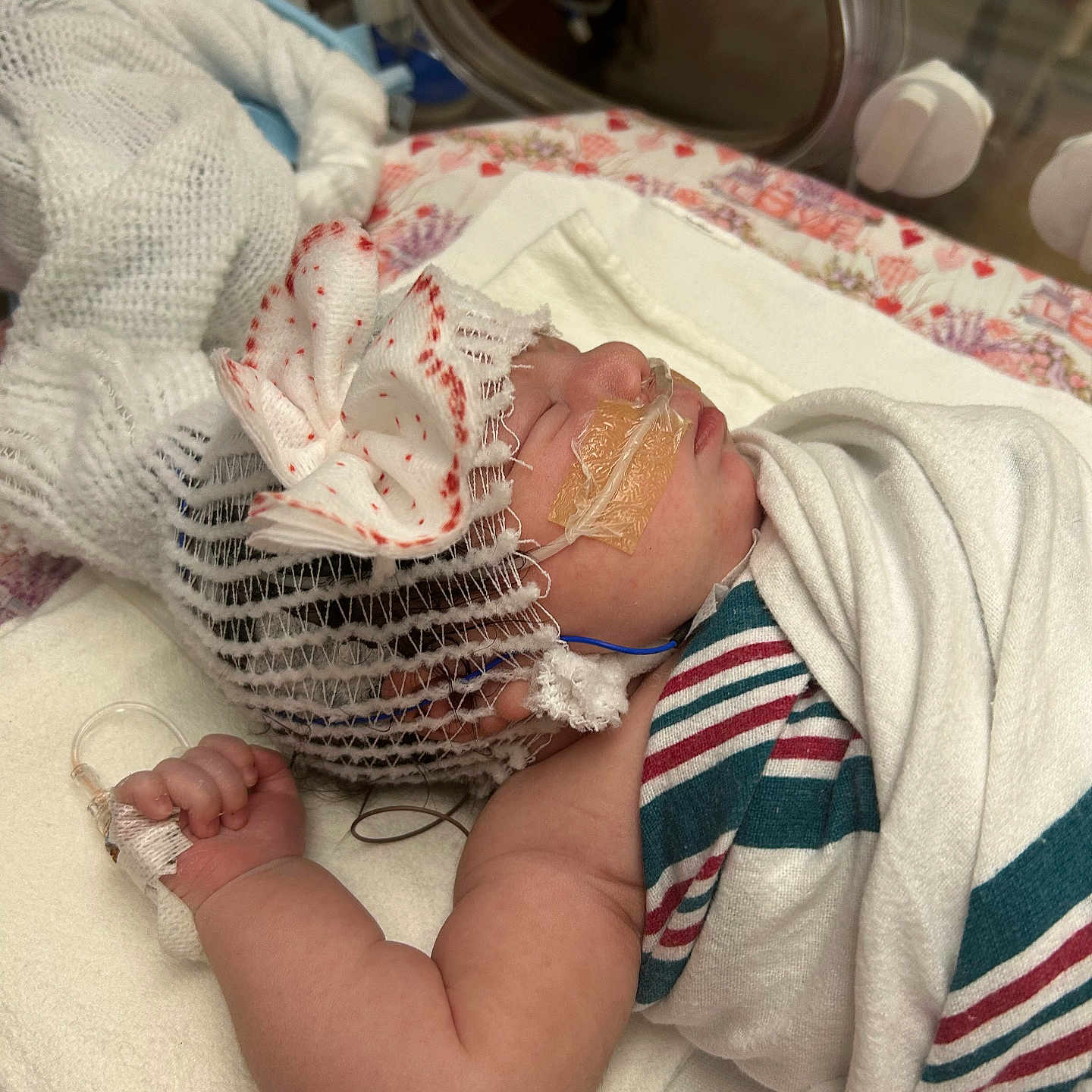 Gabriella is registered to the contest to win money with this photo: baby, bed, blanket, bow, cap, child, closeup, cute, healthcare, hospital, indoors, infant, medical_tube, newborn, patient, peaceful, person, sleeping, soft, wrapped