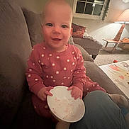 Ellie is registered to the contest to win money with this photo: architecture, baby, building, couch, cushion, cutlery, face, food, furniture, head, homedecor, indoors, livingroom, meal, person, photography, portrait, room, sitting, spoon