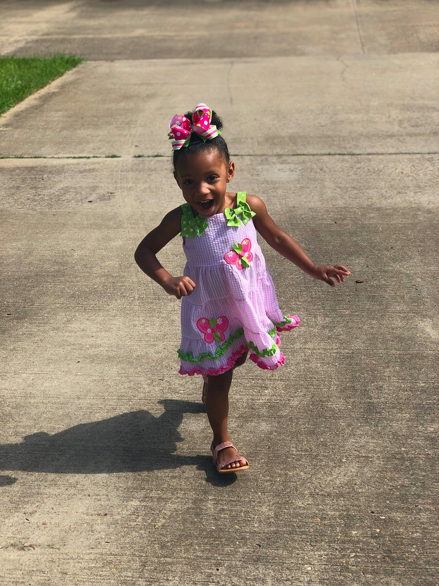 Morghan is registered to the contest to win money with this photo: adaptation, asphalt, child, dress, flower, fun, hair_accessory, headgear, person, pink, plant, play, skin, smile, summer, toddler, tree, vacation, walking