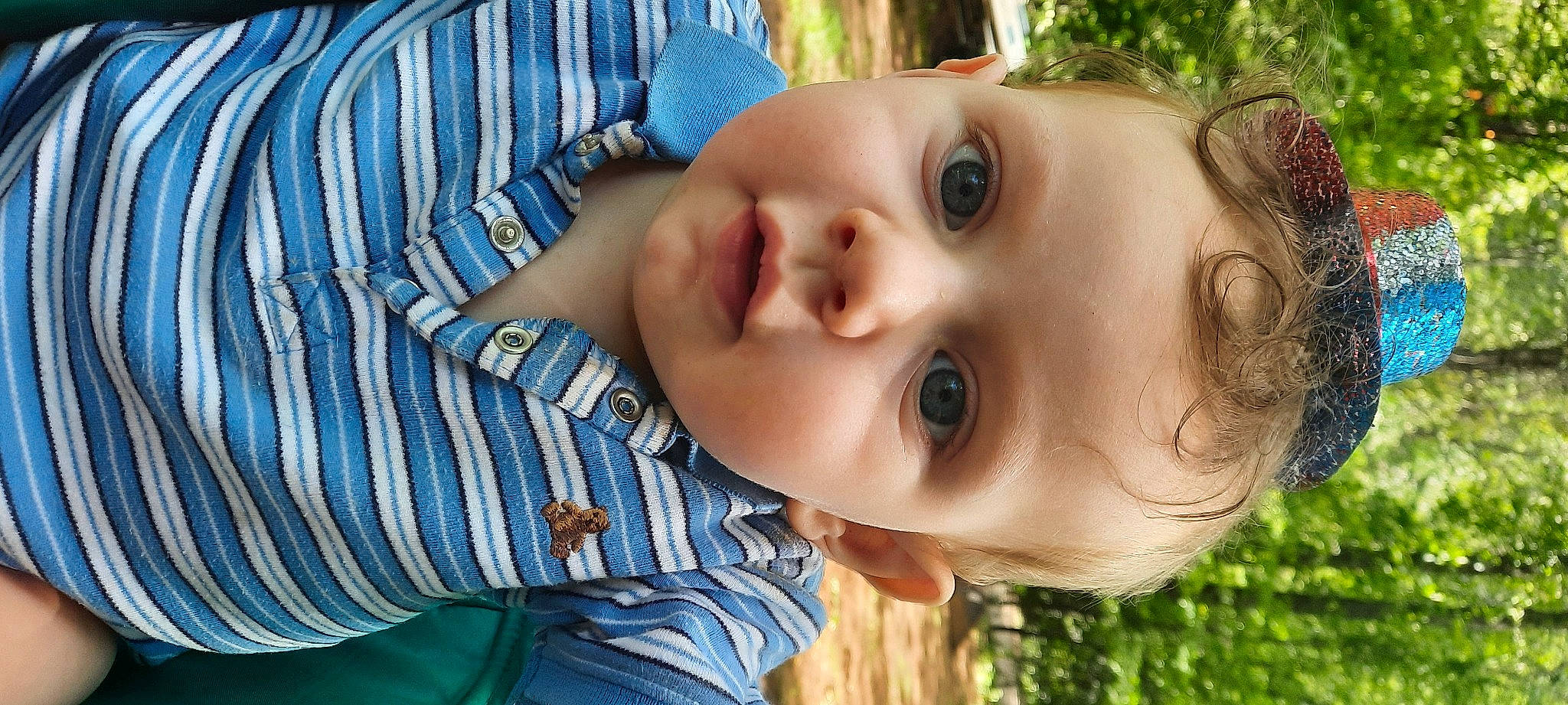 Memphis is registered to the contest to win money with this photo: baby, cheek, child, chin, eyelash, grass, happy, iris, leisure, lip, mouth, neck, nose, people_in_nature, person, plant, skin, smile, toddler, tree