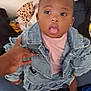 baby, child, denim_jacket, pink_shirt, tongue_out, couch, hand, indoor, clothing, blanket, leopard_print, foot, person, cute, expression, standing, support, casual, young_child, home