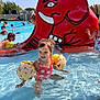 child, pool, water, swimsuit, floaties, red_elephant_slide, summer, outdoor, sunny, smiling, playing, family, fun, recreation, leisure, children, splashing, swimming_pool, people, daylight