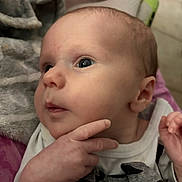 Colson joined the competition — help win amazing prizes! baby, infant, face, hand, eyes, clothing, portrait, skin, expression, cute, newborn, person, indoor, soft_texture, blanket, closeup, curious, young, head, resting