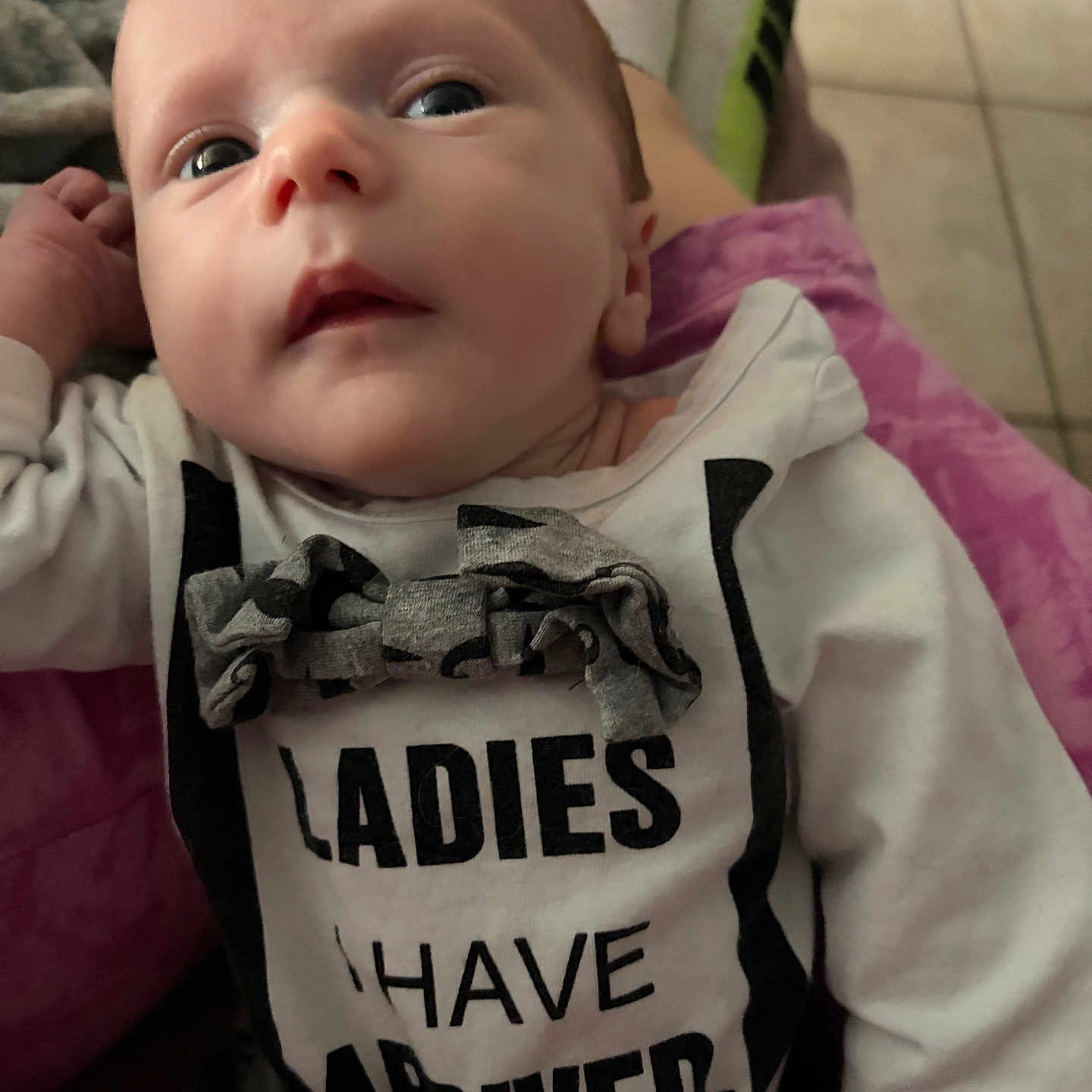 Colson joined the competition — help win amazing prizes! baby, infant, child, face, eyes, clothing, shirt, text, sitting, person, indoors, floor, fabric, bow, hand, portrait, cute, young, casual, expression