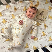Audriana joined the competition — help win amazing prizes! baby, infant, smiling, onesie, headband, bow, crib, blanket, winnie_the_pooh, milestone_card, four_months, floral_pattern, happy, face, child, lying_down, cute, indoors, soft_lighting, person