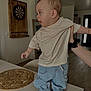 Malo a rejoint le concours — aidez-le/la à gagner de superbes lots ! toddler, child, indoor, table, clothing, jeans, shirt, socks, hand, person, curious, standing, support, dartboard, placemat, home, furniture, floor, light, expression