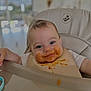 Malo a rejoint le concours — aidez-le/la à gagner de superbes lots ! baby, high_chair, bib, messy, orange_food, smile, face, blue_eyes, child, infant, feeding, food, mess, cute, happy, indoor, person, young_child, table, playful