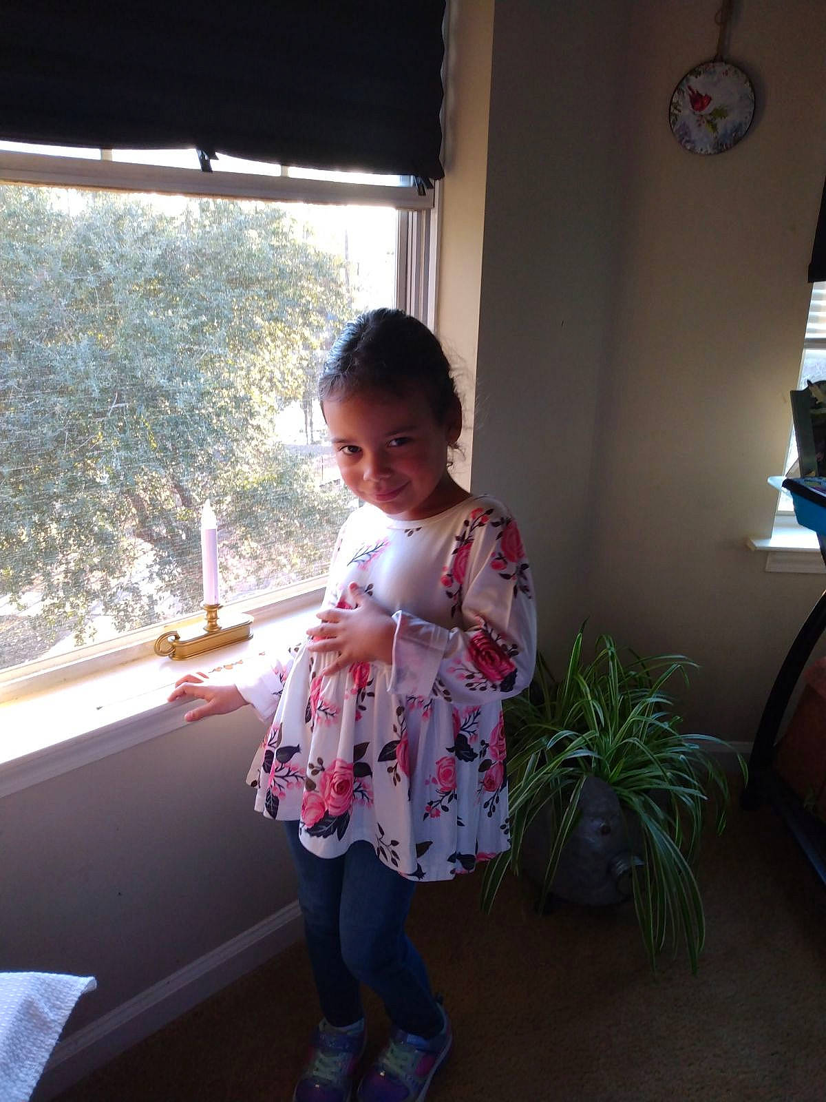 Londyn is registered to the contest to win money with this photo: baby_toddler_clothing, child, flooring, flowerpot, fun, happy, houseplant, joy, knee, leisure, magenta, pattern, person, plant, room, sandal, sitting, sleeve, toddler, vacation