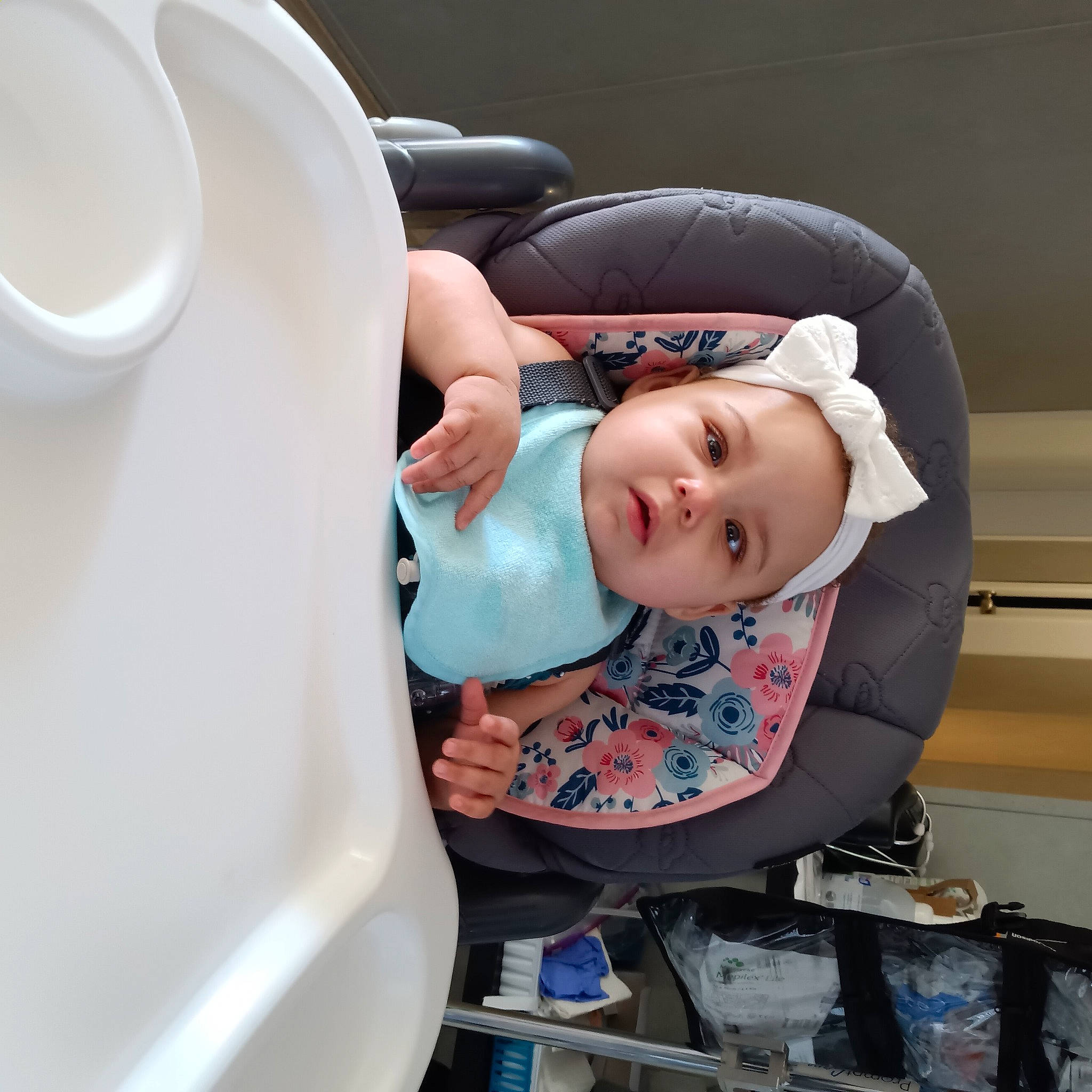 Paris is registered to the contest to win money with this photo: auto_part, automotive_design, baby, baby_carriage, baby_products, baby_safety, baby_toddler_clothing, car_seat, child, comfort, cup, dishware, headwear, person, personal_protective_equipment, porcelain, serveware, service, sitting, tableware