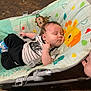 baby, sleeping, bouncer, baby_bouncer, infant, clothing, straps, animal_print, floor, wooden_floor, footwear, foot, hand, person, indoors, cute, resting, child, toddler, comfortable