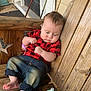 baby, child, wooden_bench, red_shirt, jeans, barefoot, baby_bottle, fishing_rods, wooden_wall, porch, outdoor, casual, sitting, cute, infant, curly_hair, relaxed, daylight, plush, home