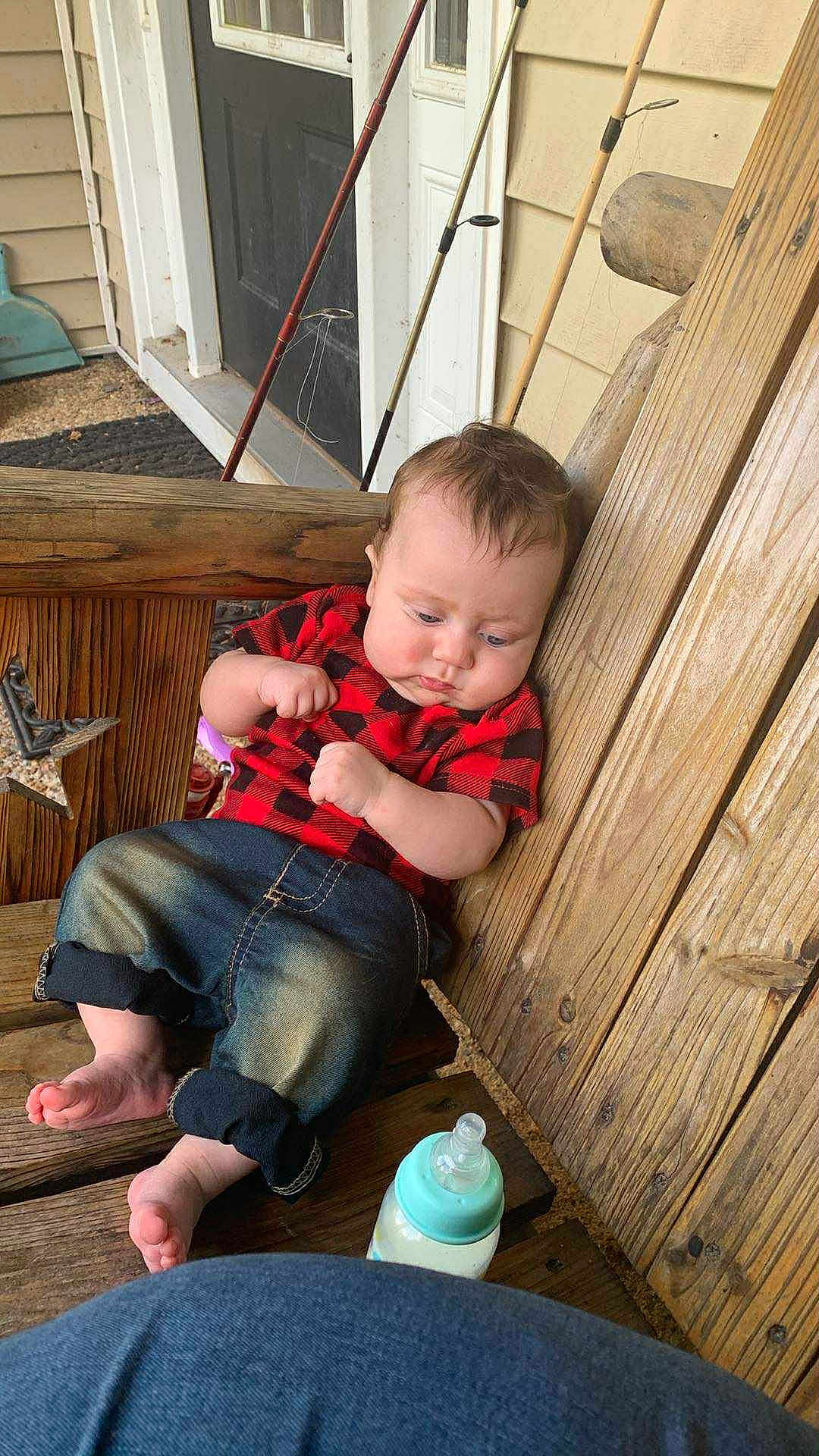 Nero joined the competition — help win amazing prizes! baby, child, wooden_bench, red_shirt, jeans, barefoot, baby_bottle, fishing_rods, wooden_wall, porch, outdoor, casual, sitting, cute, infant, curly_hair, relaxed, daylight, plush, home