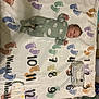 Nero is registered to the contest to win money with this photo: baby, blanket, footprints, numbers, diaper, wipes, floor, green_onesie, cloud_pattern, infant, baby_milestone, lying_down, baby_clothing, baby_boy, baby_face, indoors, tiled_floor, baby_pose, child, baby_bedding