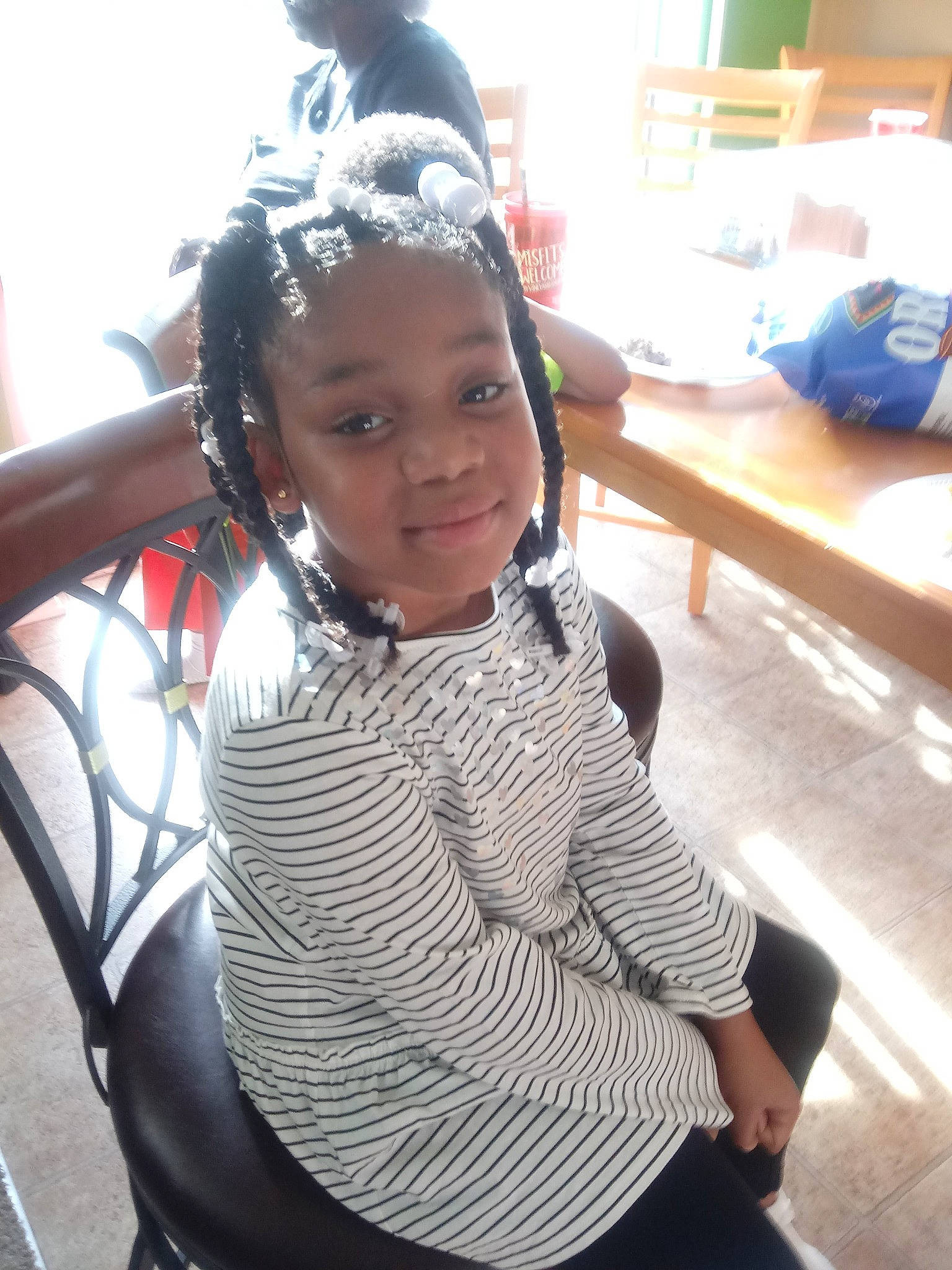 Saniyah is registered to the contest to win money with this photo: child, girl, hair, hairstyle, headgear, neck, person, product, shoulder, textile