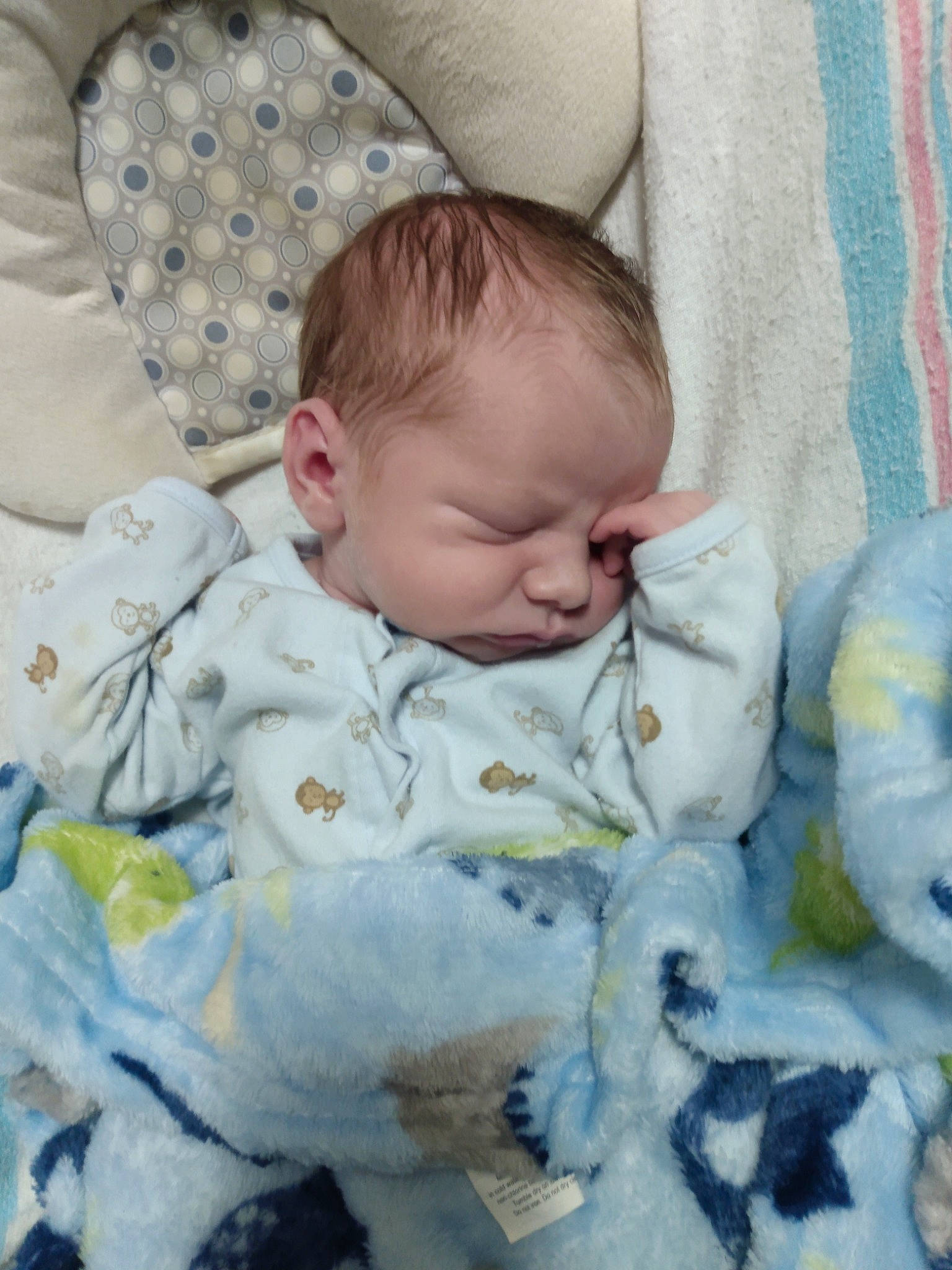 Josiah is registered to the contest to win money with this photo: baby, baby_products, baby_sleeping, baby_toddler_clothing, bedding, bedtime, cheek, child, comfort, face, grass, grey, head, linens, pattern, person, sitting, skin, sleeve, textile
