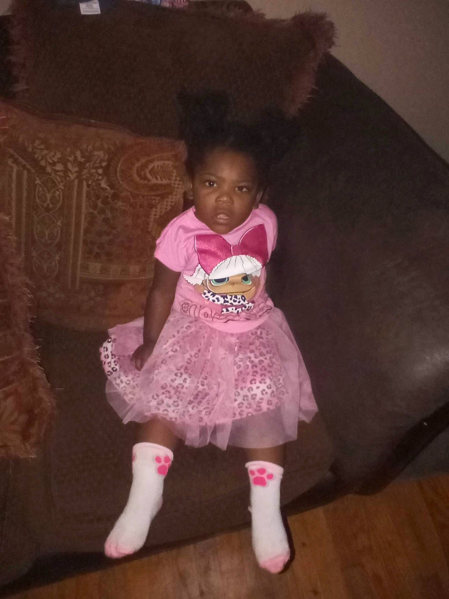 Heavenly Lawson is registered to the contest to win money with this photo: baby, baby_toddler_clothing, cheek, comfort, couch, dress, embellishment, eye, floor, flooring, hardwood, human_body, iris, magenta, person, pink, purple, sleeve, sock, toddler