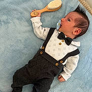 Dominic joined the competition — help win amazing prizes! baby, blue_blanket, bow_tie, button, child, clothing, cute, face, hairstyle, hand, indoors, infant, lying_down, pacifier, portrait, red_socks, smiley_face, soft_texture, suspenders, wooden_brush