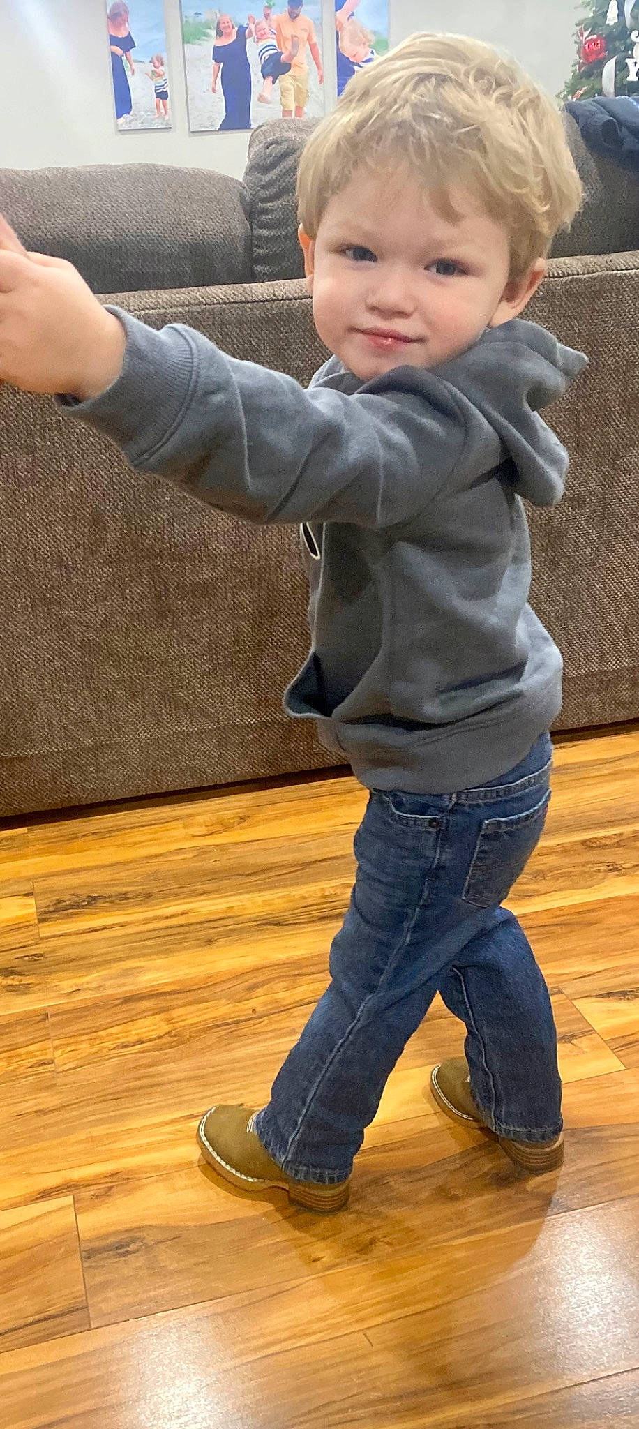 Kashton is registered to the contest to win money with this photo: baby, baby_toddler_clothing, child, denim, eye, face, floor, flooring, fun, gesture, happy, hardwood, jeans, leg, person, sleeve, smile, toddler, varnish, wood