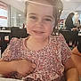 background, casual, child, dining, face, floral_dress, furniture, hair, hand, happy, indoor, lens_flare, light, people, person, portrait, restaurant, seated, smile, table