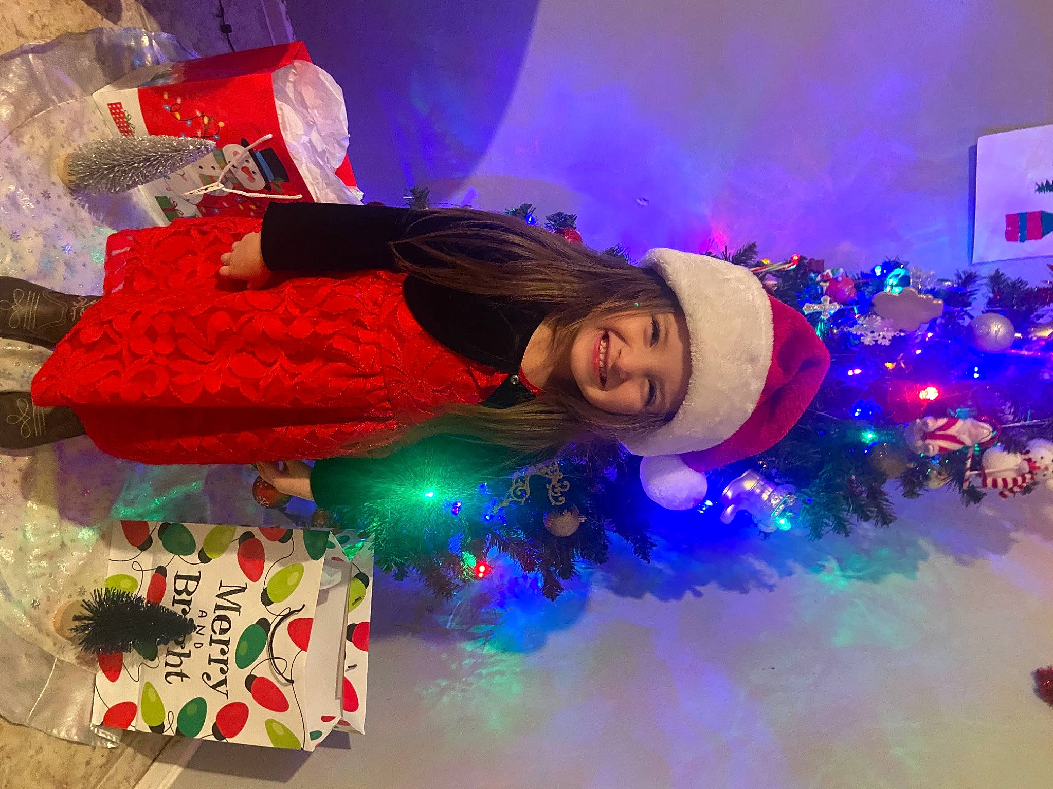 Meredith is registered to the contest to win money with this photo: christmas, christmas_decoration, christmas_eve, christmas_lights, christmas_ornament, christmas_tree, fur, fur_clothing, headwear, holiday, joy, ornament, person, winter