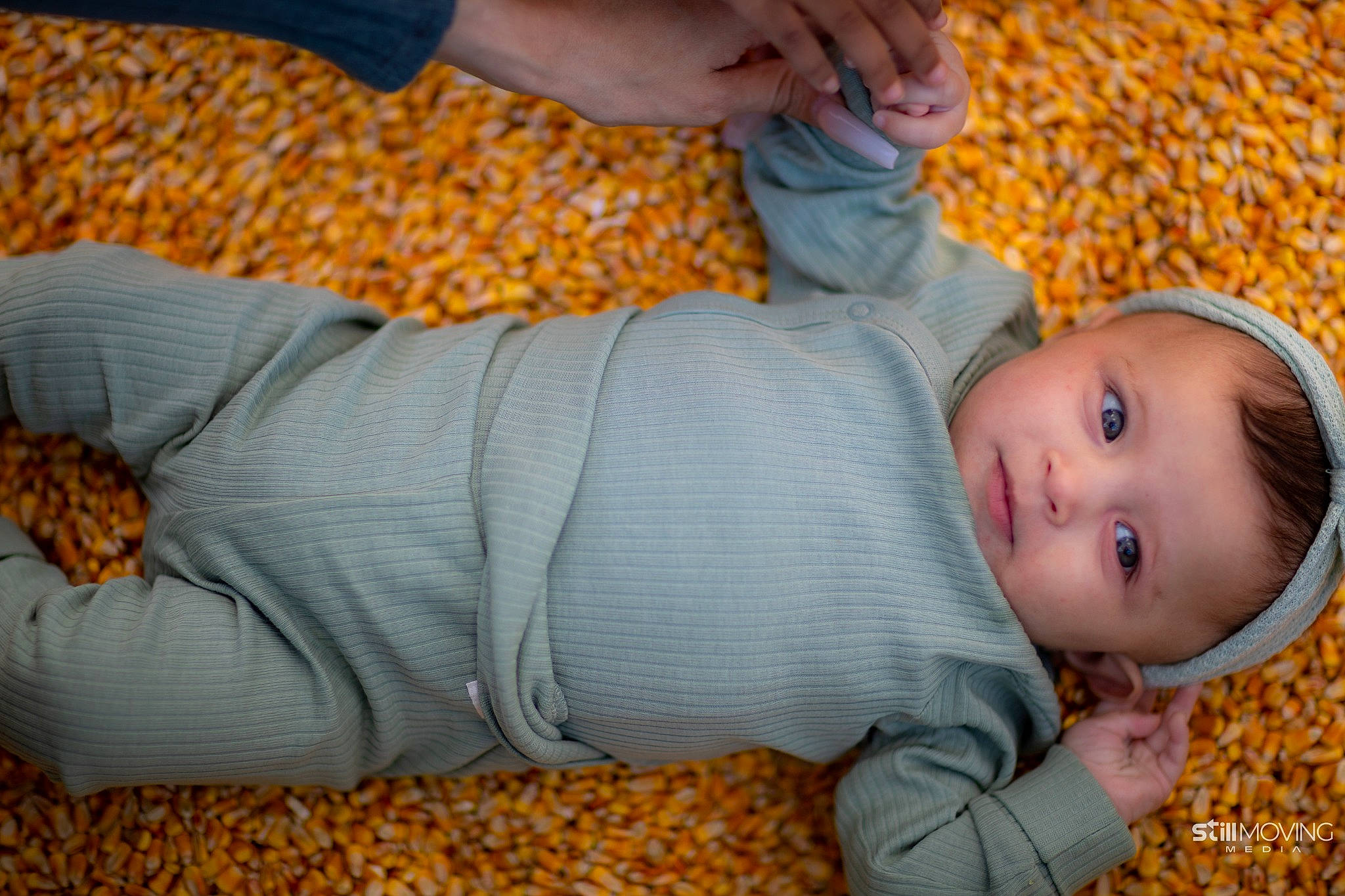 Amelia is registered to the contest to win money with this photo: baby, baby_toddler_clothing, child, clothing, comfort, finger, flooring, grass, head, human_leg, linens, orange, pattern, person, room, sitting, skin, toddler, wood, wool