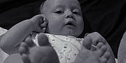 Scott joined the competition — help win amazing prizes! baby, infant, feet, hand, black_and_white, portrait, lying_down, clothing, fabric, bed, blanket, skin, cute, child, person, small, human, closeup, relaxing, indoor