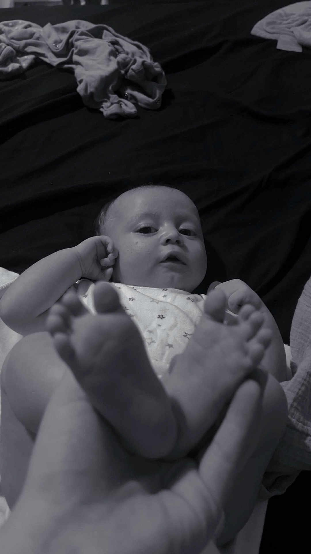 Scott joined the competition — help win amazing prizes! baby, infant, feet, hand, black_and_white, portrait, lying_down, clothing, fabric, bed, blanket, skin, cute, child, person, small, human, closeup, relaxing, indoor