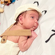 Aren joined the competition — help win amazing prizes! baby, infant, hat, suspenders, lying_down, blanket, plush_toy, cute, child, skin, face, arm, headwear, indoors, pattern, soft_toy, newborn, resting, person, sleepwear