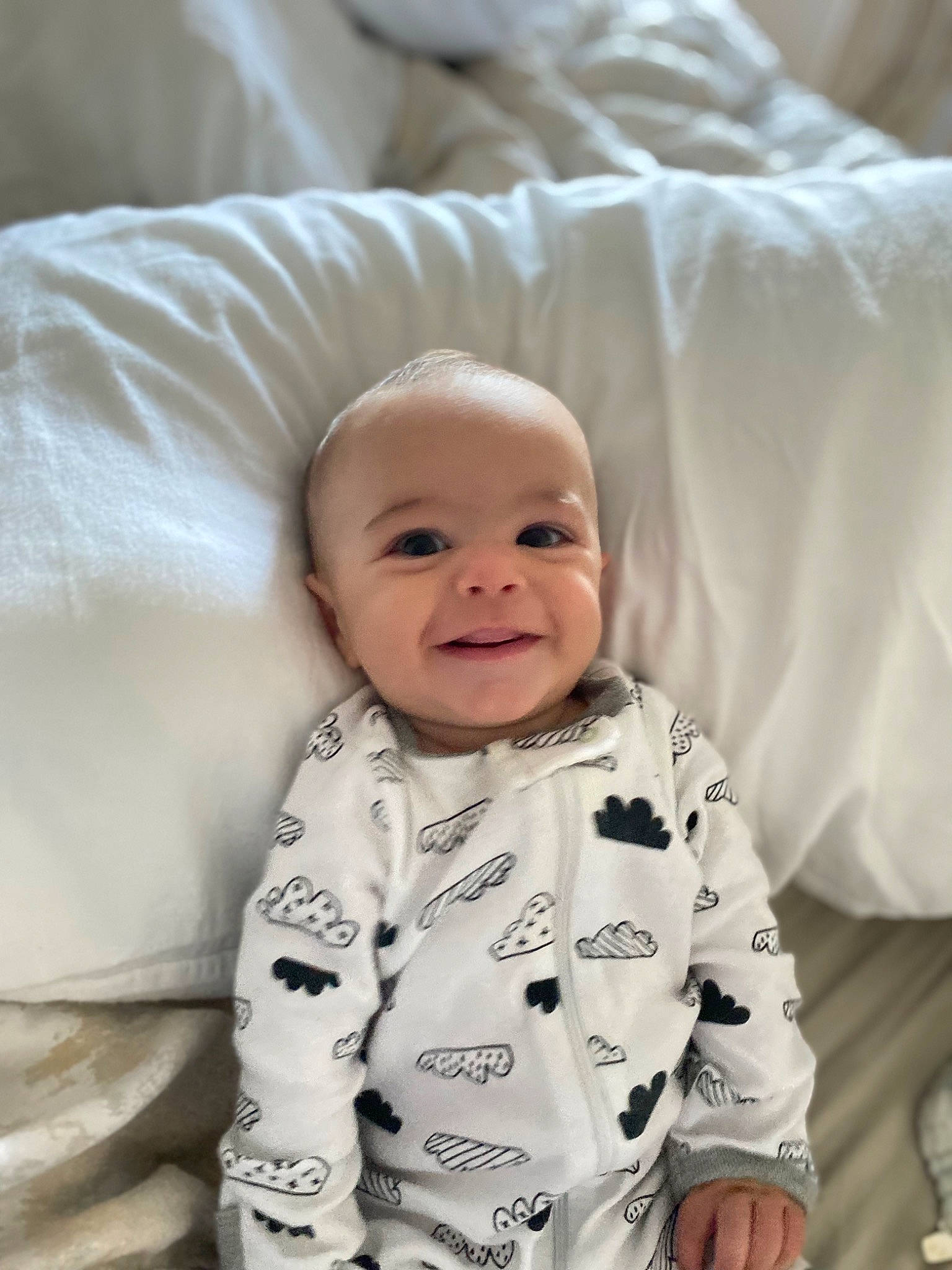 Kodi is registered to the contest to win money with this photo: baby, baby_toddler_clothing, cheek, child, comfort, face, fun, happy, iris, joy, linens, mammal, pattern, person, sitting, skin, sleeve, smile, t_shirt, textile