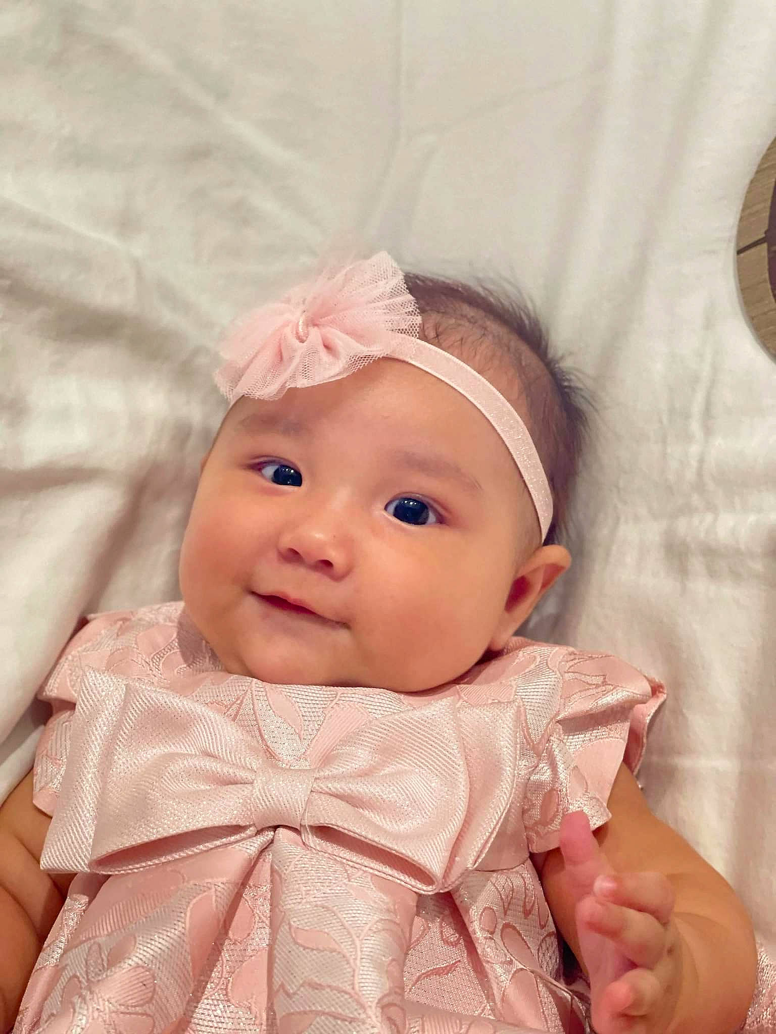 Marina is registered to the contest to win money with this photo: baby, baby_toddler_clothing, cheek, child, collar, comfort, eye, eyebrow, eyelash, face, facial_expression, fashion_accessory, happy, headwear, iris, joy, linens, lip, person, pink