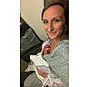 newborn, baby, woman, hospital, blanket, hat, feeding_tube, smile, mother, infant, person, holding, indoor, closeup, healthcare, care, comfort, love, parent, tender