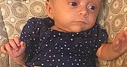 Allie is registered to the contest to win money with this photo: baby, baby_seat, bow, child, clothing, cute, expression, fabric, headband, indoors, infant, looking_away, pattern, portrait, seatbelt, sitting, small_feet, small_hands, soft_lighting, straps