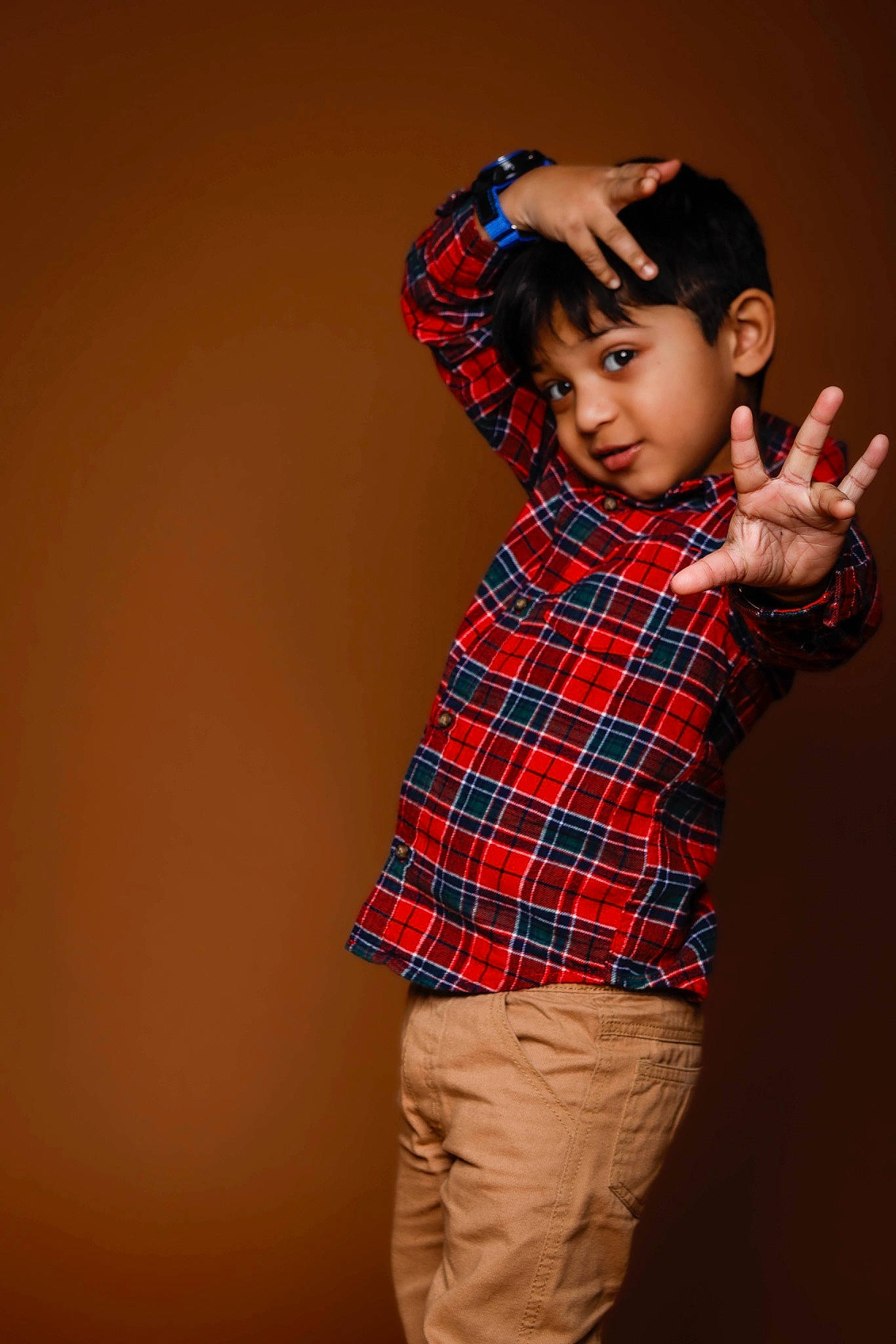 Raegan Joshy is registered to the contest to win money with this photo: arm, collar, dress_shirt, elbow, face, flash_photography, gesture, hair, hand, happy, neck, pattern, person, plaid, shoulder, sleeve, t_shirt, tartan, toddler, waist