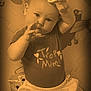 baby, child, infant, play_mat, toy, ring, shirt, clothing, curious, face, expression, hand, pose, indoor, floor, cute, sepia, closeup, person, young