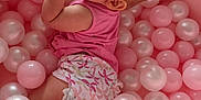 Séréna a rejoint le concours — aidez-le/la à gagner de superbes lots ! baby, infant, pink, ball_pit, plastic_balls, child, diaper, sleeveless_top, cute, playtime, indoor, skin, feet, hand, face, looking_up, soft_lighting, floor, curious, childhood
