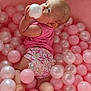 baby, infant, pink, ball_pit, plastic_balls, child, diaper, sleeveless_top, cute, playtime, indoor, skin, feet, hand, face, looking_up, soft_lighting, floor, curious, childhood