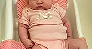 Romey is registered to the contest to win money with this photo: baby, infant, pink_onesie, baby_seat, mesh_strap, white_frame, cute, chubby_cheeks, serious_expression, indoor, child, newborn, soft_lighting, sitting, footwear, sock, portrait, young_child, plush, comfortable