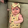 Romey joined the competition — help win amazing prizes! baby, infant, child, couch, headband, yellow_outfit, heart_pattern, pacifier, cute, portrait, indoors, comfortable, smile, skin, face, eyes, sitting, furniture, relaxed, young