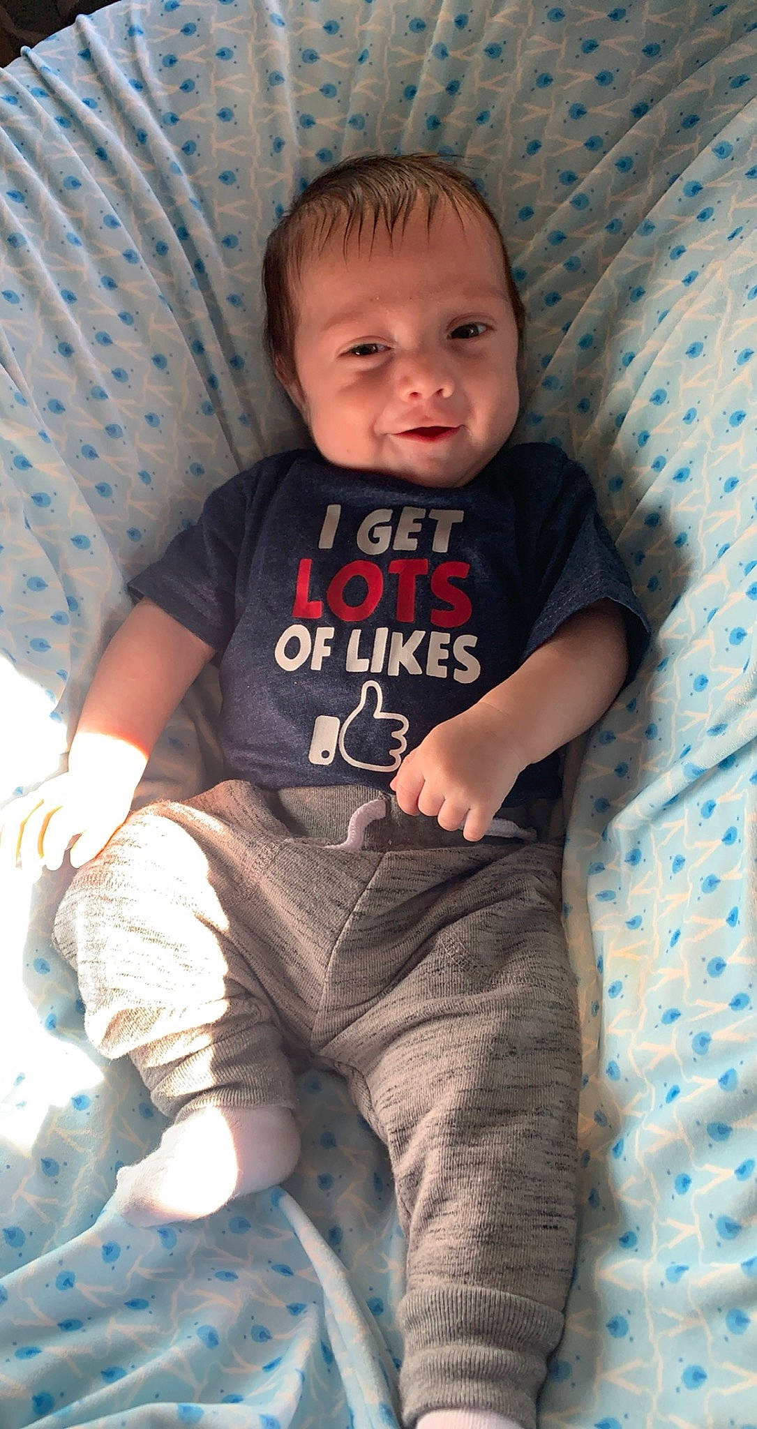 Maverick is registered to the contest to win money with this photo: baby, baby_toddler_clothing, cheek, child, person, sitting, skin, smile, t_shirt, toddler